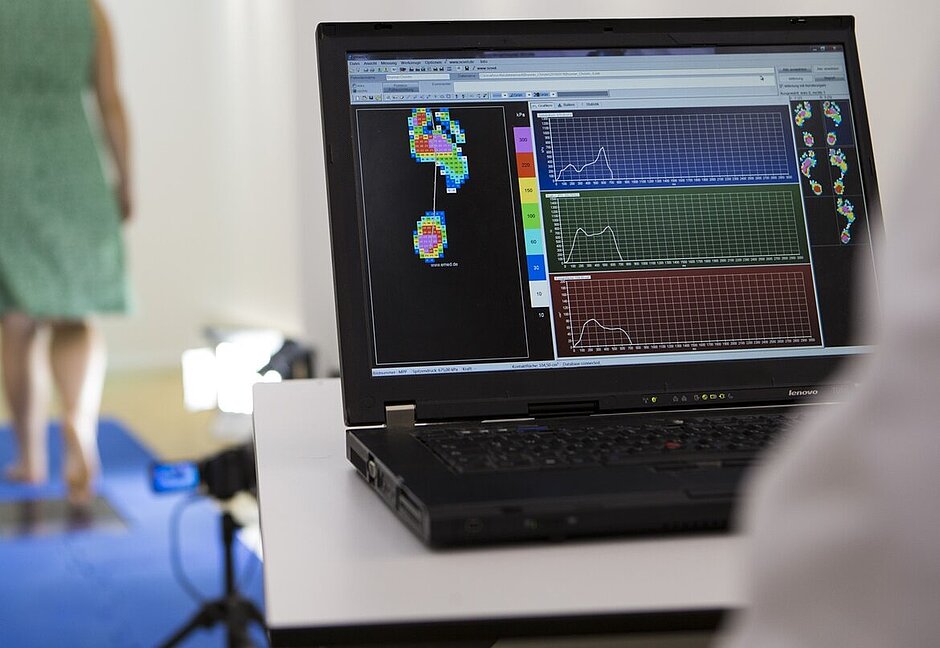 Ein Laptop zeigt eine grafische Auswertung einer Fußdruckmessung